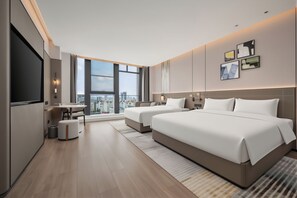 A modern hotel room with a large bed, a desk, and a view of the cityscape. - Grand Skylight Hotel Qingdao (Qingdao)
