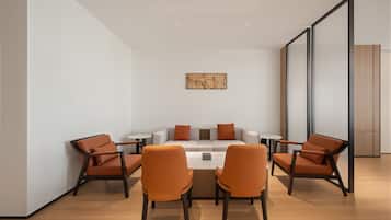 A modern meeting room with a round table, six chairs, and a minimalist decor.