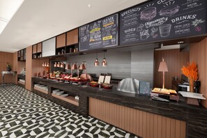 A modern restaurant with a chalkboard menu, a variety of dishes, and a clean, geometric floor pattern. - Grand Skylight Hotel Qingdao (Qingdao)