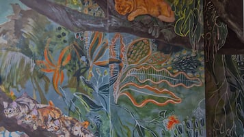 A mural with various animals and abstract designs.