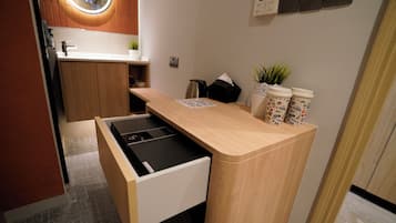 A compact kitchenette with a built-in stove, a small sink, and a countertop.