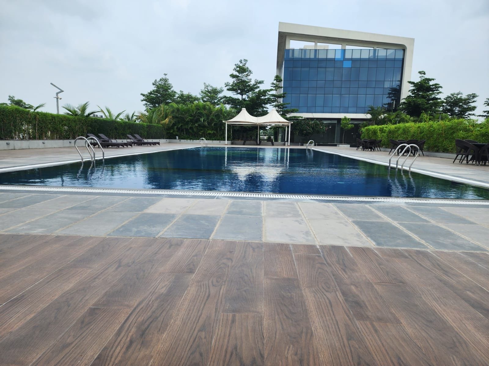 A swimming pool with a modern building in the background.