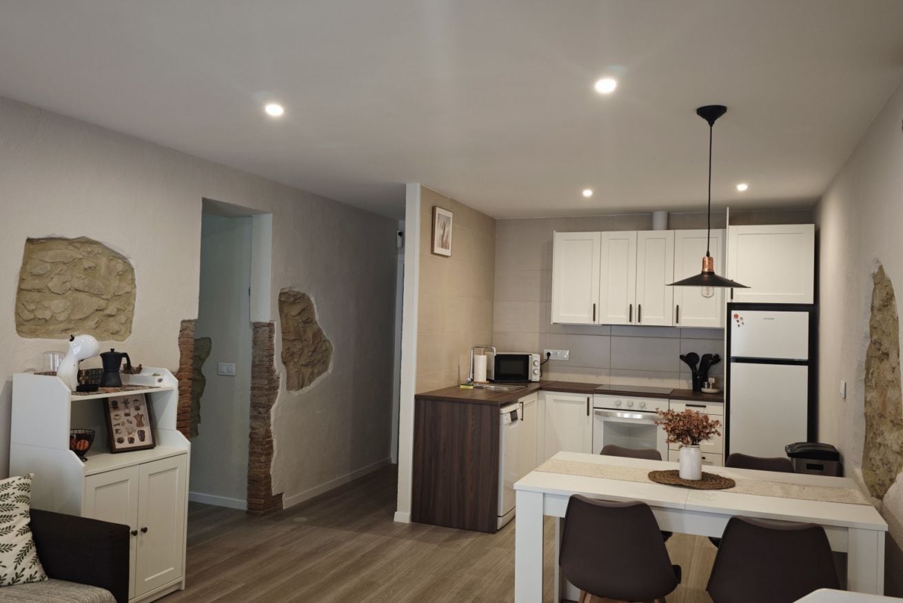 A compact kitchen with white cabinets, a microwave, and a sink.