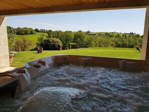 Uma banheira de hidromassagem com vista para uma paisagem verde.