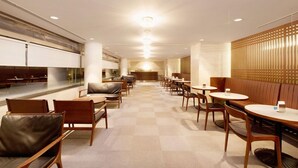 A modern interior with a checkered floor, wooden furniture, and a central bar area. - Rockwood Hotel and Spa (Ajigasawa)