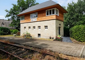 A two-story building with a stone facade and a wooden upper section, labeled 'RINGELSTEIN.' - Stellwerk Ringelstein: Forest-Edge Retreat with Sauna, Fireplace, Terrace & Wi-Fi (Büren)