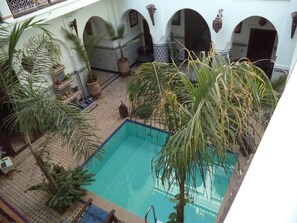 An indoor swimming pool with multiple arches and potted plants. - Dar moulay Ali (MARRAKECH)