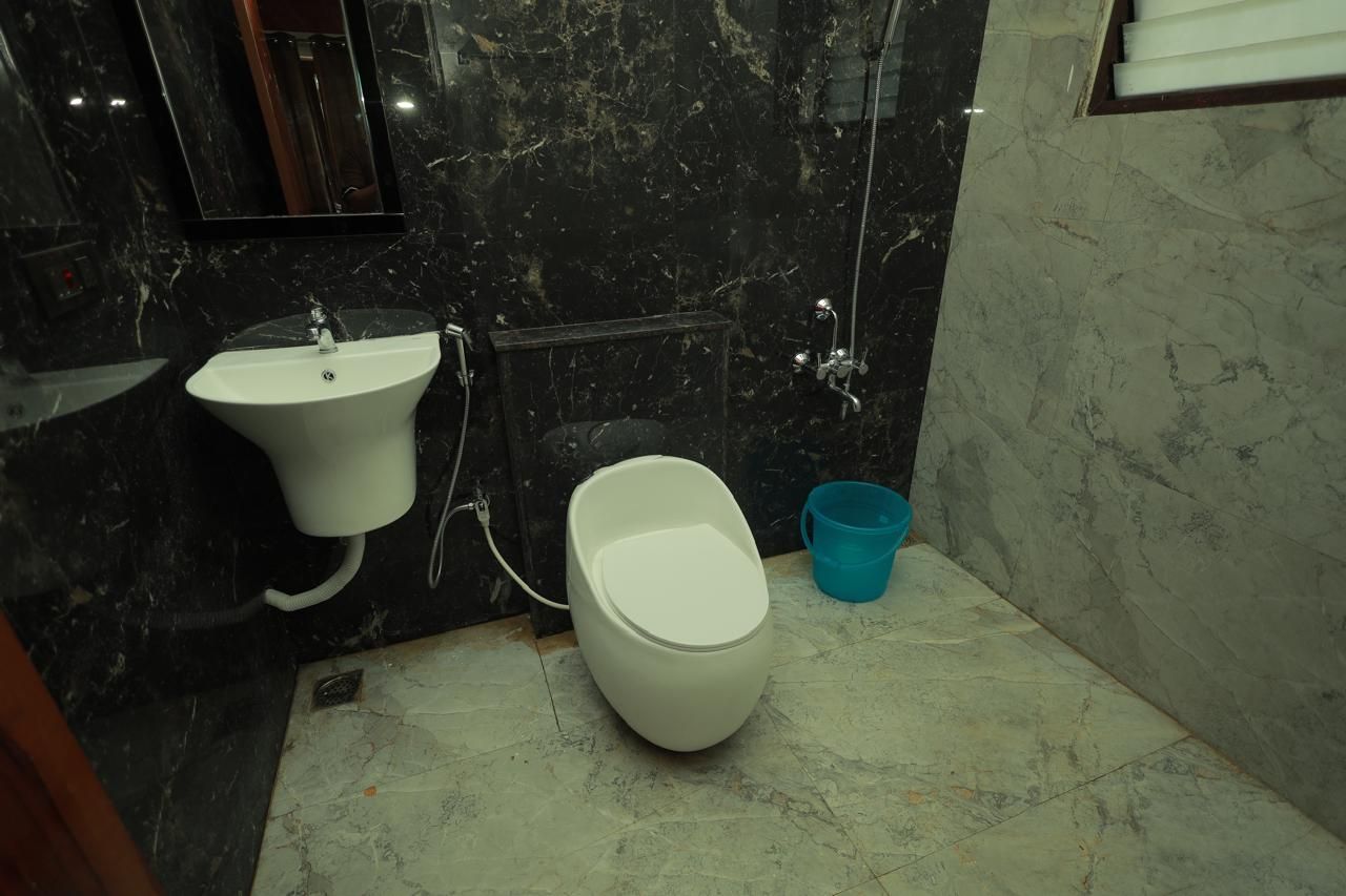 A bathroom with a sink, toilet, and shower.