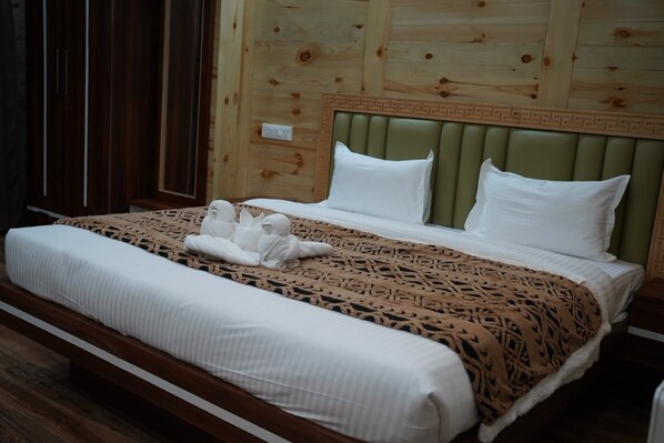 A hotel room with a bed, a headboard, and a wardrobe. - Hotel Tashi Khangzang Tawang (Tawang)