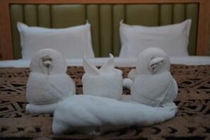 A bed with white pillows and a green headboard.