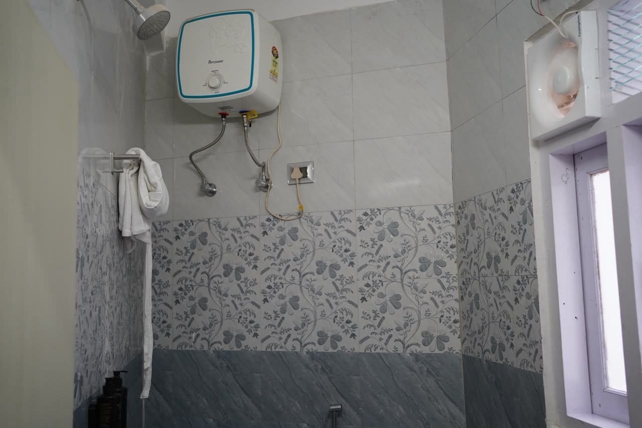 A bathroom with a shower, a toilet, and a sink.