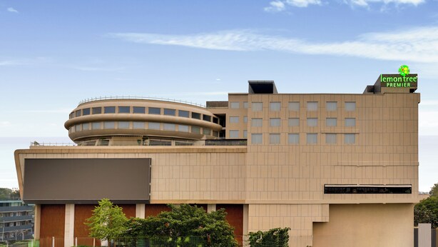 A modern building with a curved structure, a flat roof, and a sign indicating it's a premier hotel. - Lemon Tree Premier, Jabalpur (Jabalpur)