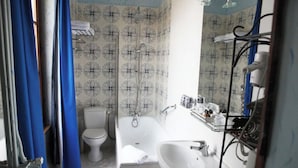 A bathroom with a toilet, bathtub, and sink. - Château D'Island: Delphine Suite (Island)