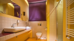 A bathroom with a sink, toilet, and shower area. - Centrum Dikul (Wroclaw)