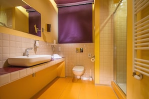 A bathroom with a sink, toilet, and shower area. - Centrum Dikul (Wroclaw)