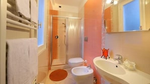 A bathroom with a shower, toilet, bidet, and sink. - Arma (Taggia)