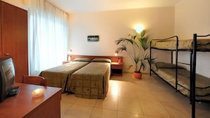 A hotel room with two beds, a desk, a chair, a television, a potted plant, and a bunk bed. - Arma (Taggia)