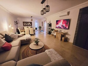 A modern living room with a sofa, coffee table, and a flat-screen TV. - 3 Bed Apartment - Sleeps 6 - Pool - Parking - Golf (Mijas)