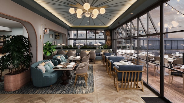 A modern interior with a seating area, tables, and large windows offering a view. - White Horse Hotel (Brighton)