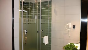 A modern bathroom with a glass-enclosed shower, a white sink, and a potted plant. - Greentree Inn Taiheng Shuijing County Jingtai Street (Hengshui)