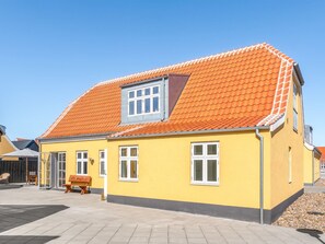 A yellow building with a red-tiled roof, a small window, and a bench outside. - "Judyta" - 500m from the sea by Interhome (Skagen)