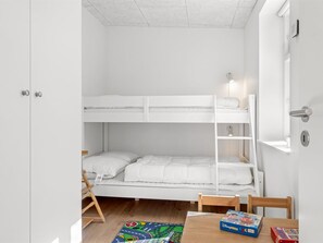 A bunk bed room with a desk and chair, a window with blinds, and a door. - "Judyta" - 500m from the sea by Interhome (Skagen)