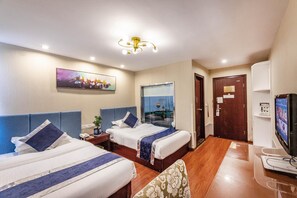 A hotel room with two beds, a television, a desk, and a painting on the wall. - Greentree Inn Suzhou Wujiang Yongkang Pedestrian Road Hotel (Suzhou)