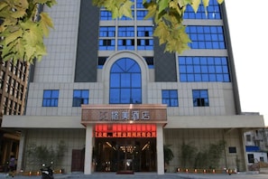 A hotel with a modern facade, large windows, and a prominent entrance.