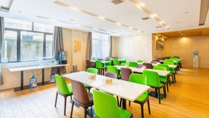 A conference room with tables and chairs, large windows, and a water dispenser. - Greentree Inn Anhui Suzhou Si District Bianhe Avenue Business Hotel (Suzhou)