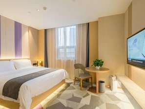 A hotel room with a large bed, a desk with a chair, a television, and a window with curtains. - Lavande Hotel Wuhan Qushuilou of Xinhua Road (Wuhan)