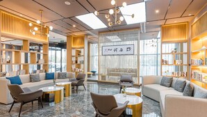 A modern lounge area with sofas, chairs, and a central coffee table. - Atour Hotel Wangting Suzhou (Suzhou)