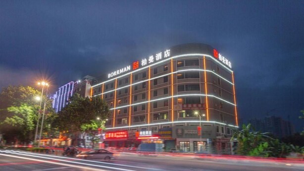 A multi-story hotel with illuminated signage and a modern architectural design. - Borrman Hotel (Huizhou)