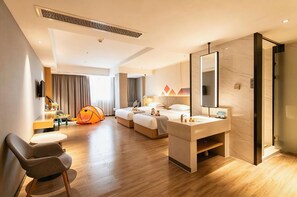A hotel room with a sofa, two beds, a desk, a mirror, and a tent. - Borrman Hotel (Huizhou)