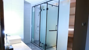 A modern bathroom with a glass shower enclosure, a white sink, and a marble countertop. - Borrman Hotel Hengyang Huaxin Caixia Street (Hengyang)