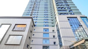 A multi-story building with a prominent entrance, large windows, and signage. - City Comfort Inn Enshi Jingang Baijia Plaza (Enshi)