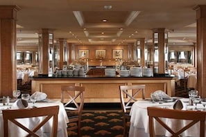 A spacious dining area with high ceilings, large windows, and a central bar. - JAZ Crown Jubilee Nile Cruise - Thursday VIA Luxor 7 & 4nts - Monday VIA Aswan 3nts (Luxor)