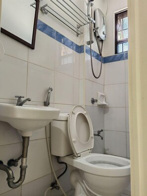 Ein Badezimmer mit Toilette, Waschbecken und Dusche.