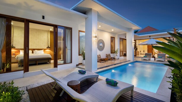 A modern hotel with a swimming pool, outdoor seating, and a well-lit interior. - Monaco Blu Luxury Villas and Spa (Keroboken Kelod)