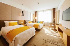 A hotel room with two beds, a desk, a chair, a television, and a large window with curtains. - Club Med Joyview Beijing Yanqing (Beijing)