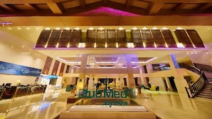 A spacious lobby with a modern design, featuring a central staircase and a reception area. - Club Med Joyview Beijing Yanqing (Beijing)