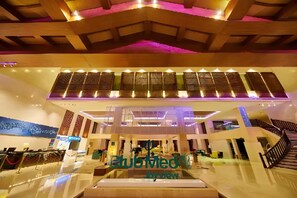 A spacious lobby with a modern design, featuring a central staircase and a reception area. - Club Med Joyview Beijing Yanqing (Beijing)
