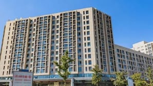 A multi-story building with a grid of windows and a flat roof. - West Mansion Hotel Beijing (Beijing)
