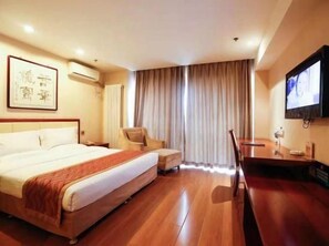 A hotel room with a bed, a desk, a chair, a TV, and a window with curtains. - West Mansion Hotel Beijing (Beijing)