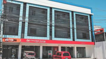 A commercial building with a blue and white facade, featuring storefronts for 'triphn' and 'Chino Bank Savings'.