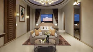 A spacious living room with a sofa, coffee table, and a television.