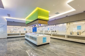 A modern kitchen with a central island, marble countertops, and a bright overhead light fixture. - Holiday Inn Express Qidong Economic Zone (Nantong)