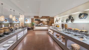 A buffet setup with various food items and serving ware.