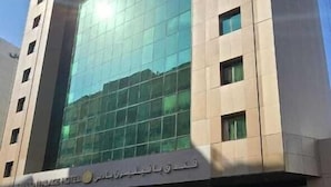 A modern hotel building with a large glass facade and a flat roof. - Pavilion Palace Hotel (Sharjah)