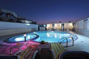 A rooftop swimming pool with lounge chairs and a hot tub area. - Pavilion Palace Hotel (Sharjah)