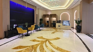 A lobby with a reception desk, seating area, and a decorative ceiling. - Pavilion Palace Hotel (Sharjah)